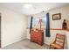 Cozy bedroom with natural light, neutral walls, and wooden dresser at 2911 S Olathe Way, Aurora, CO 80013