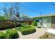 Backyard garden with brick pathway, lush landscaping, and privacy fence at 12154 W Exposition Dr, Lakewood, CO 80228