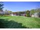 Large backyard with a well-maintained lawn, mature trees, and shed at 12154 W Exposition Dr, Lakewood, CO 80228