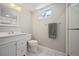 Bright bathroom with white vanity, tiled floors, and a glass-enclosed shower at 12154 W Exposition Dr, Lakewood, CO 80228