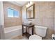 Bathroom with modern sink, framed mirror, and tiled shower-tub combo at 12154 W Exposition Dr, Lakewood, CO 80228