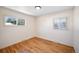 Bedroom featuring hardwood floors, two windows, and neutral walls at 12154 W Exposition Dr, Lakewood, CO 80228