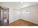 Bedroom featuring hardwood floors, a closet, a window, and neutral walls at 12154 W Exposition Dr, Lakewood, CO 80228