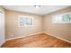 Bedroom with hardwood floors and natural light from two windows at 12154 W Exposition Dr, Lakewood, CO 80228