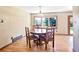 Bright dining area featuring hardwood floors, natural light, and a cozy table setting at 12154 W Exposition Dr, Lakewood, CO 80228