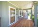 Inviting front porch showcases a wooden deck, stylish door, and views of the surrounding neighborhood at 12154 W Exposition Dr, Lakewood, CO 80228