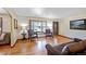 Comfortable living room featuring hardwood floors, natural light, and a cozy seating area at 12154 W Exposition Dr, Lakewood, CO 80228