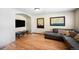 Relaxing living area boasts hardwood floors, a modern TV setup, and stylish decor at 12154 W Exposition Dr, Lakewood, CO 80228
