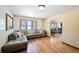 Inviting living area offering hardwood floors, large windows, and an open flow to the dining space at 12154 W Exposition Dr, Lakewood, CO 80228
