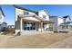 Back of home with covered porch and sliding glass doors with new construction at 1080 Joseph Pl, Erie, CO 80026