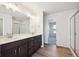 Spacious bathroom featuring double vanity, large mirror, and glass enclosed shower at 1080 Joseph Pl, Erie, CO 80026