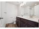 Bathroom featuring double sink vanity with dark cabinets, white countertop, and shower at 1080 Joseph Pl, Erie, CO 80026