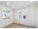 Inviting bedroom featuring a large window and light wood-look flooring at 1080 Joseph Pl, Erie, CO 80026