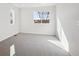 Bright bedroom featuring neutral carpet, two windows, and fresh white walls at 1080 Joseph Pl, Erie, CO 80026