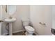 Compact half bath featuring a pedestal sink and white toilet at 1080 Joseph Pl, Erie, CO 80026