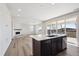 Modern kitchen featuring an island, wood floors, and stainless steel appliances at 1080 Joseph Pl, Erie, CO 80026