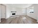 Bright living room with a fireplace, wood flooring, and large windows at 1080 Joseph Pl, Erie, CO 80026