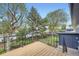 Enjoy outdoor living on this deck, featuring black iron railings, a wood floor, and neighborhood views at 6876 Quay Ct, Arvada, CO 80003