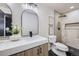 Modern bathroom featuring a marble countertop, wood cabinet, and a sleek black shower at 6876 Quay Ct, Arvada, CO 80003