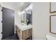 Bathroom with double sinks, marble countertops, and modern lighting at 6876 Quay Ct, Arvada, CO 80003