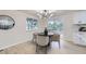 Bright dining area with a modern light fixture and sliding glass doors to the outside at 6876 Quay Ct, Arvada, CO 80003