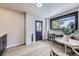 Bright dining area with white brick accent, a modern light fixture, breakfast bar with stool seating and natural light at 6876 Quay Ct, Arvada, CO 80003