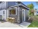 Modern exterior featuring a stylish bar area with seating and a unique pass-through window at 6876 Quay Ct, Arvada, CO 80003