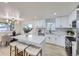 Bright kitchen featuring an island with seating and modern appliances and finishes at 6876 Quay Ct, Arvada, CO 80003