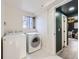 Laundry room with side-by-side washer and dryer and view to open door at 6876 Quay Ct, Arvada, CO 80003