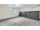 Basement living room features a brick fireplace and large window at 6876 Quay Ct, Arvada, CO 80003
