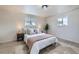 Cozy main bedroom featuring neutral decor, soft lighting, and windows for natural light at 6876 Quay Ct, Arvada, CO 80003