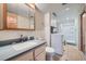 Bathroom with sink, vanity, toilet, shower, medicine cabinet, and washer/dryer combo at 16463 E Girard Ave, Aurora, CO 80013