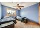 Bright bedroom with carpeting, a ceiling fan, and two twin beds at 16463 E Girard Ave, Aurora, CO 80013
