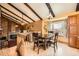 Inviting dining room with vaulted ceilings, exposed beams, fireplace and large windows at 16463 E Girard Ave, Aurora, CO 80013