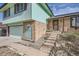 Home featuring brick accents, an arched doorway, and steps leading to the front door at 16463 E Girard Ave, Aurora, CO 80013