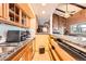 Kitchen and pass-through featuring granite countertops, modern appliances, and a view to the living room at 16463 E Girard Ave, Aurora, CO 80013