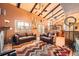 Spacious living room featuring vaulted ceilings, exposed beams, and comfortable seating area at 16463 E Girard Ave, Aurora, CO 80013