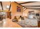Bright living room with vaulted ceilings, exposed beams, seating, and open floor plan at 16463 E Girard Ave, Aurora, CO 80013