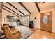 Living room with vaulted ceilings, exposed beams, two chairs, and a bay window at 16463 E Girard Ave, Aurora, CO 80013