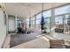 Bright sunroom features large windows, punching bag, and gym equipment, creating a workout space at 16463 E Girard Ave, Aurora, CO 80013