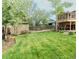 Large backyard with a deck, a lush lawn and mature trees at 357 Saturn Pl, Lone Tree, CO 80124
