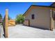 Long backyard driveway behind a tan home with wood fence and concrete area for parking at 357 Saturn Pl, Lone Tree, CO 80124