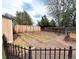 Backyard with multiple garden beds, gravel area, and mature trees at 357 Saturn Pl, Lone Tree, CO 80124