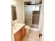 Bathroom featuring vanity, toilet, mirror and glass shower door at 357 Saturn Pl, Lone Tree, CO 80124