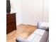 Bedroom featuring hardwood floors, neutral paint, and a comfortable gray couch at 357 Saturn Pl, Lone Tree, CO 80124