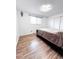 A well-lit bedroom featuring vinyl floors, a bed, and a sliding door closet at 357 Saturn Pl, Lone Tree, CO 80124