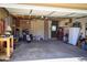Spacious two car garage with storage cabinets, a motorcycle, and access door to the backyard at 357 Saturn Pl, Lone Tree, CO 80124