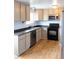 Well-lit kitchen featuring neutral cabinets, black appliances, and a stylish faucet at 357 Saturn Pl, Lone Tree, CO 80124