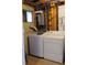 Laundry room featuring a washer, dryer, and tankless hot water heater at 357 Saturn Pl, Lone Tree, CO 80124