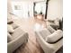 Bright living room with hardwood floors, contemporary furniture, and large windows at 357 Saturn Pl, Lone Tree, CO 80124